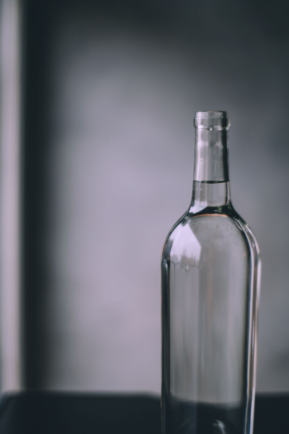 Illustrative unbranded glass water bottle
